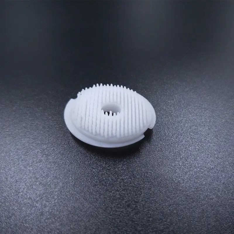 Skin-friendly LSR facial cleaning brush head with precision molded soft bristles.