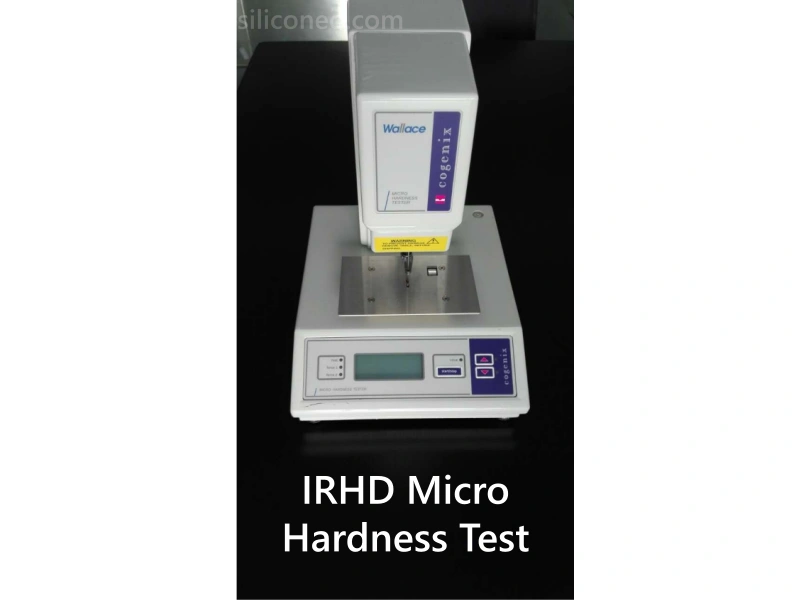 Quality control engineer performing micro-hardness testing on medical silicone using Wallace IRHD equipment.