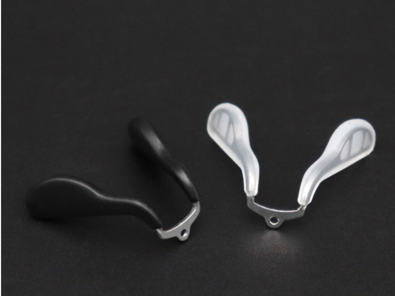 Soft-touch silicone overmolded metal nose pad designed for ergonomic comfort and long-term wearability